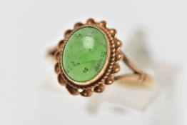 A 9CT GOLD CHRYSOPRASE SINGLE STONE RING, the oval chrysoprase cabochon collet set with rope twist