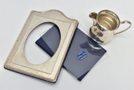 A SILVER PHOTO FRAME AND A MILK JUG, polished photo frame with beaded rim, oval aperture, hallmarked