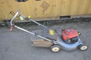 A HONDA IZY self-propelled petrol lawn mower, with grass box (condition:-engine starts first time