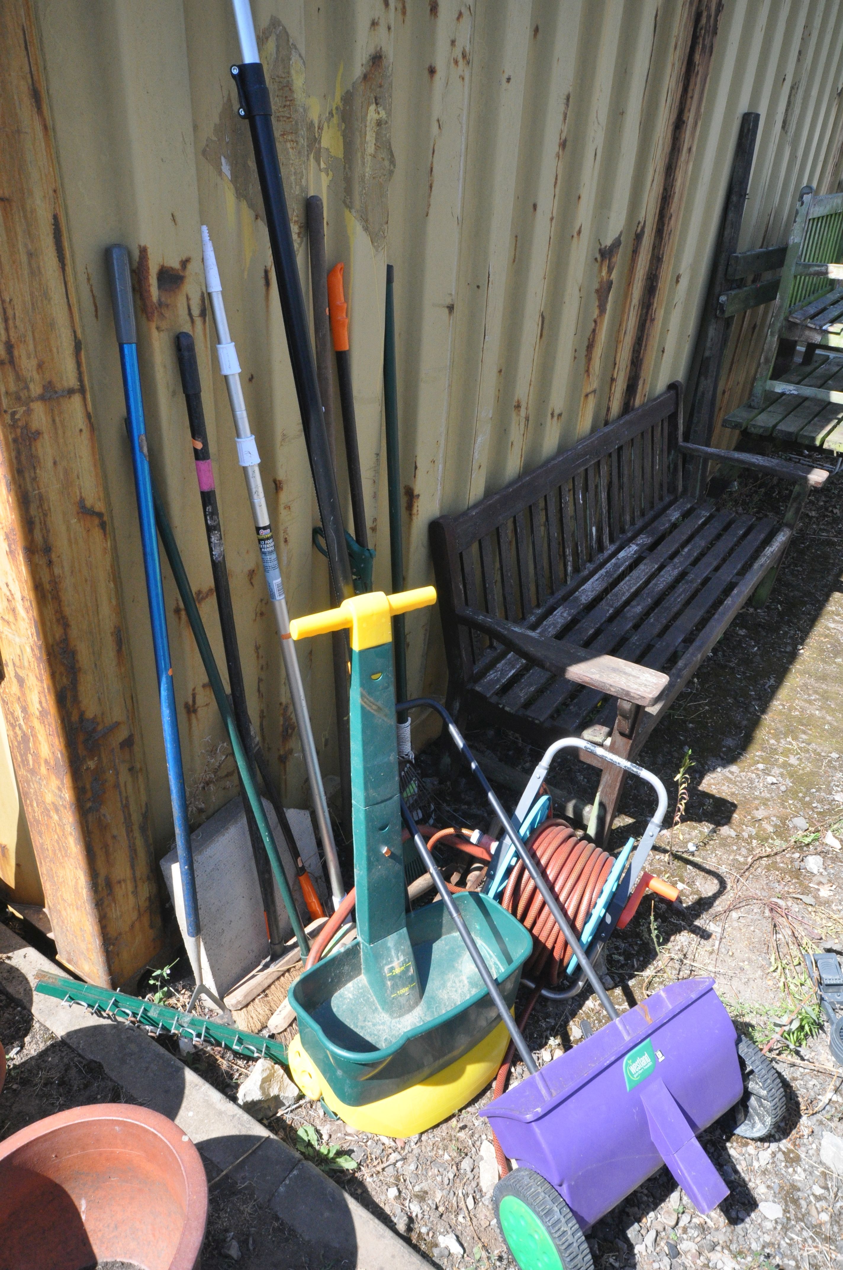 A SELECTION OF GARDEN HAND TOOLS, to include rakes, brushes, loppers, etc, along with a hose reel