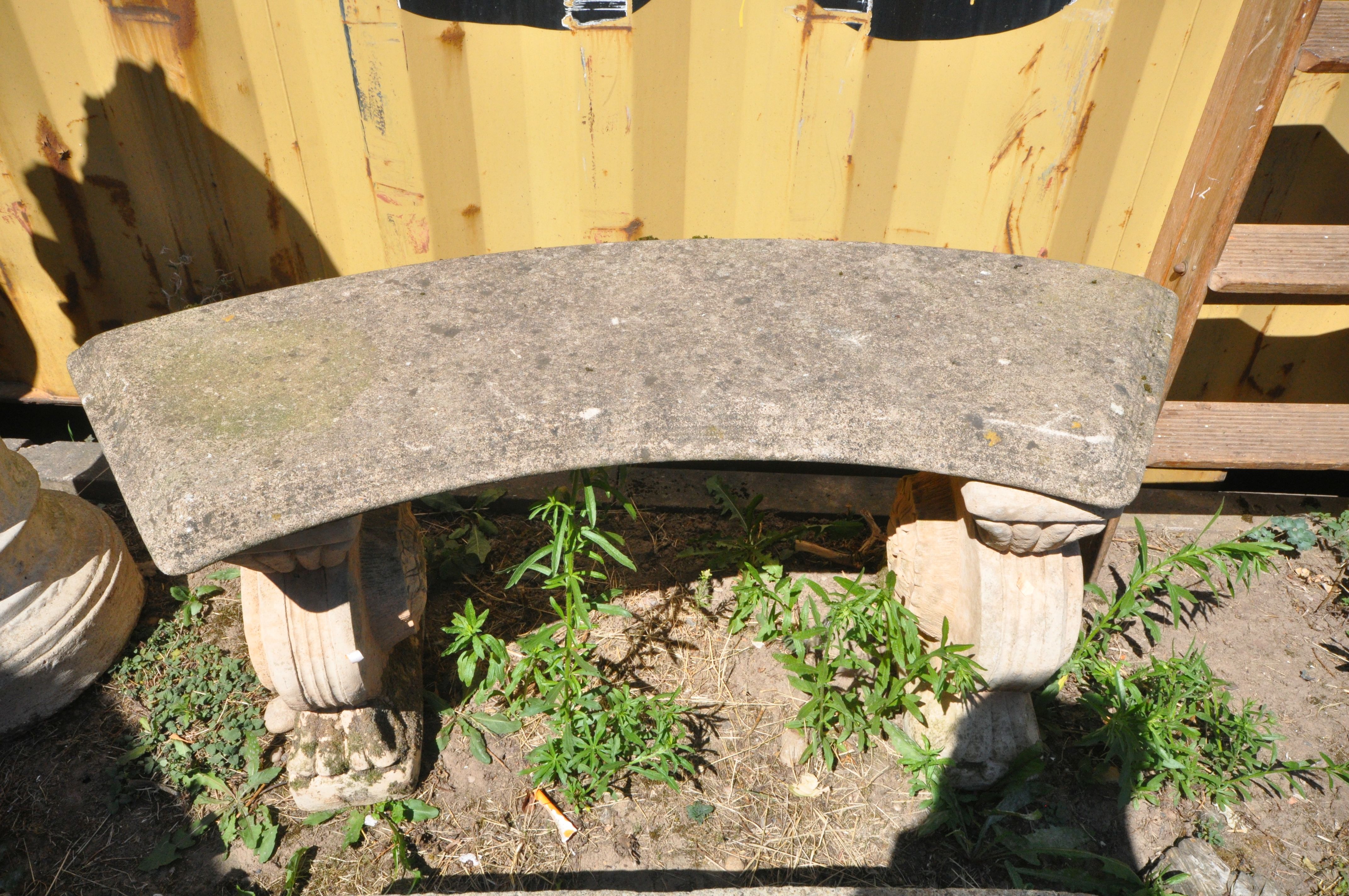 A COMPOSITE CURVED GARDEN BENCH, on twin round supports, length 120cm x height 48cm