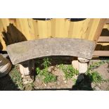 A COMPOSITE CURVED GARDEN BENCH, on twin round supports, length 120cm x height 48cm