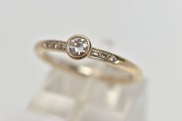 AN 18CT GOLD DIAMOND DRESS RING, the brilliant cut diamond within a collet setting, to the similarly