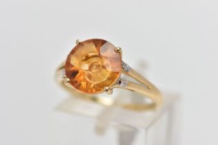 A 9CT GOLD GEM SET RING, four claw set, fancy circular cut orange stone assessed as citrine,