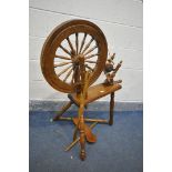 A MID CENTURY BEECH AND MAHOGANY SPINNING WHEEL (condition:-missing pin to foot pedal)