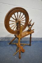 A MID CENTURY BEECH AND MAHOGANY SPINNING WHEEL (condition:-missing pin to foot pedal)
