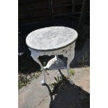 A CAST IRON PUB TABLE, with a weathered teak top, and a painted base, diameter 60cm x height 76cm