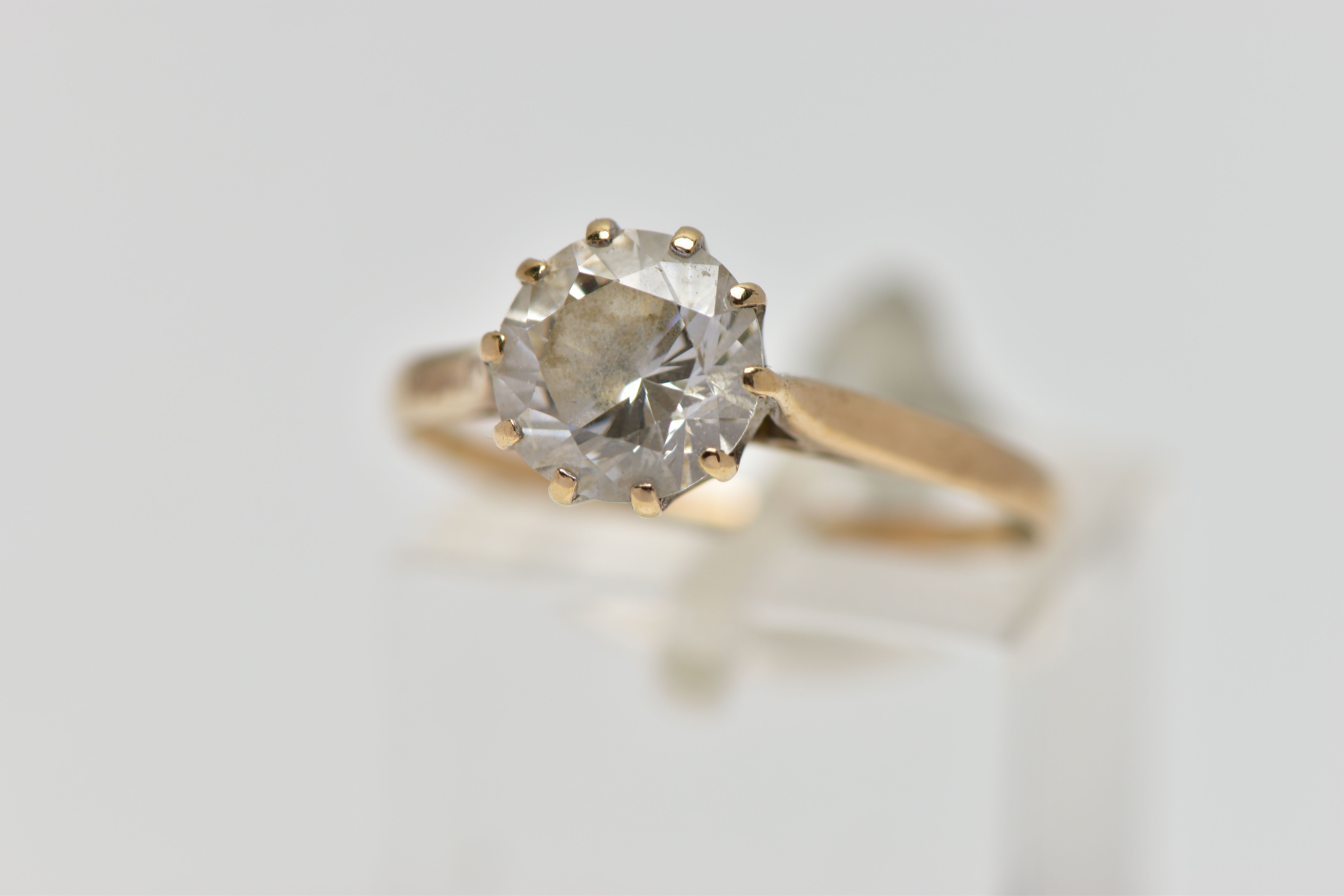 A 9CT GOLD SINGLE STONE RING, circular cut colourless cubic zirconia in a ten claw setting,