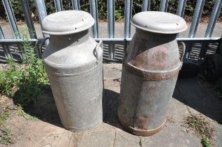 A PAIR OF GALVANISED MILK CHURNS (condition:-one slightly rusted)
