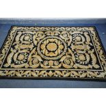 A G H FRITH WOOLLEN BLACK AND GOLD CHINESE RUG, 245cm X 152cm