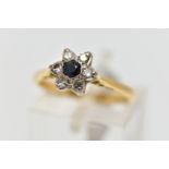 A YELLOW AND WHITE METAL CLUSTER RING, a circular cut sapphire and six single cut diamonds prong set