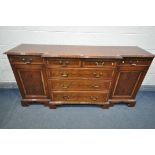 A YEW WOOD BREAKFRONT SIDEBOARD, with seven assorted drawers, and two cupboard doors, length 185cm x
