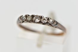 A YELLOW METAL DIAMOND FIVE STONE RING, designed as a series of graduated old and round brilliant