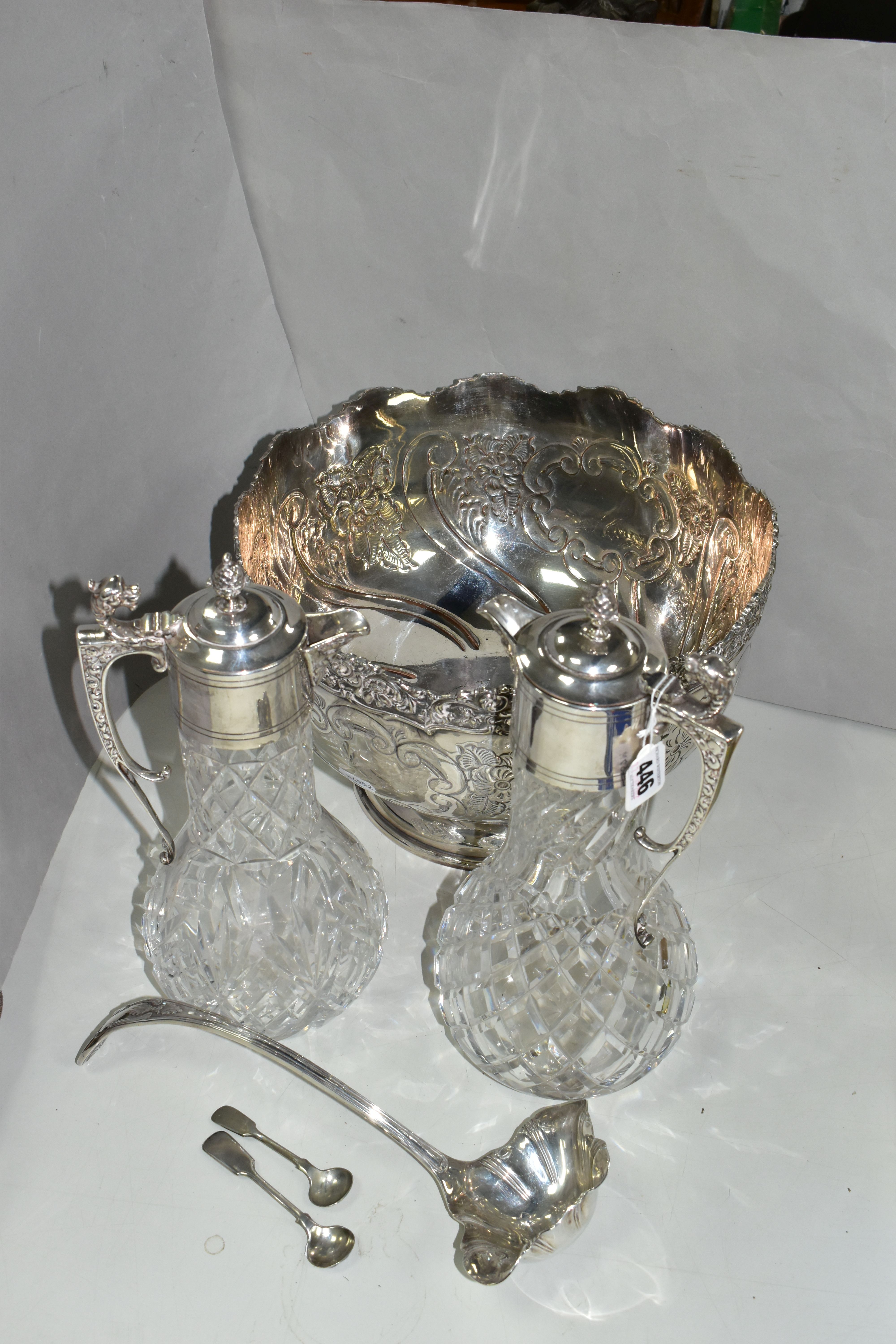 A GROUP OF SILVER PLATED ITEMS, to include a pair of cut glass plated claret jugs, a large punch