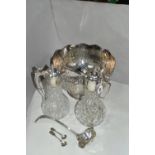 A GROUP OF SILVER PLATED ITEMS, to include a pair of cut glass plated claret jugs, a large punch