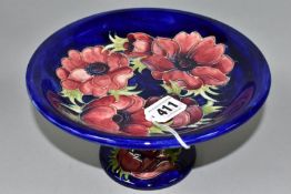 A MOORCROFT POTTERY COMPORT, in the Anemone pattern, tubelined with red anemones on a dark blue