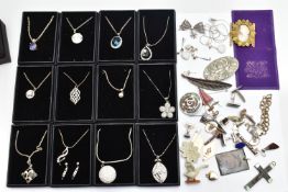 A BOX OF MOSTLY WHITE METAL JEWELLERY, to include twelve boxed (new like condition) pendant