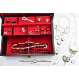 A BLACK JEWELLERY BOX WITH CONTENTS, hinged black jewellery box with a red fabric interior, together