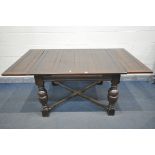 AN EARLY 20TH OAK DRAW LEAD DINING TABLE, on bulbous legs, united by a cross stretcher, open