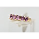 A 9CT GOLD FIVE STONE RING, designed with a row of four claw set, oval cut pink stones assessed as