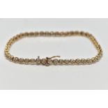 A 9CT YELLOW GOLD DIAMOND LINE BRACELET, set with approximately fifty one single cut diamonds,