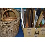 A BOX OF PICTURES, FIVE WOODEN WALKING STICKS AND TWO WICKER BASKETS, the wicker comprises a log
