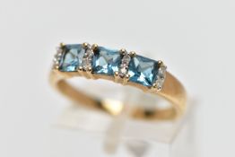 A 9CT GOLD TOPAZ AND DIAMOND DRESS RING, the cushion cut blue topaz with single cut diamond duo