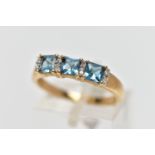 A 9CT GOLD TOPAZ AND DIAMOND DRESS RING, the cushion cut blue topaz with single cut diamond duo