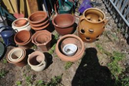 A SELECTION OF MOSTLY TERRACOTTA GARDEN PLANTERS, to include a strawberry/herb planter, a low