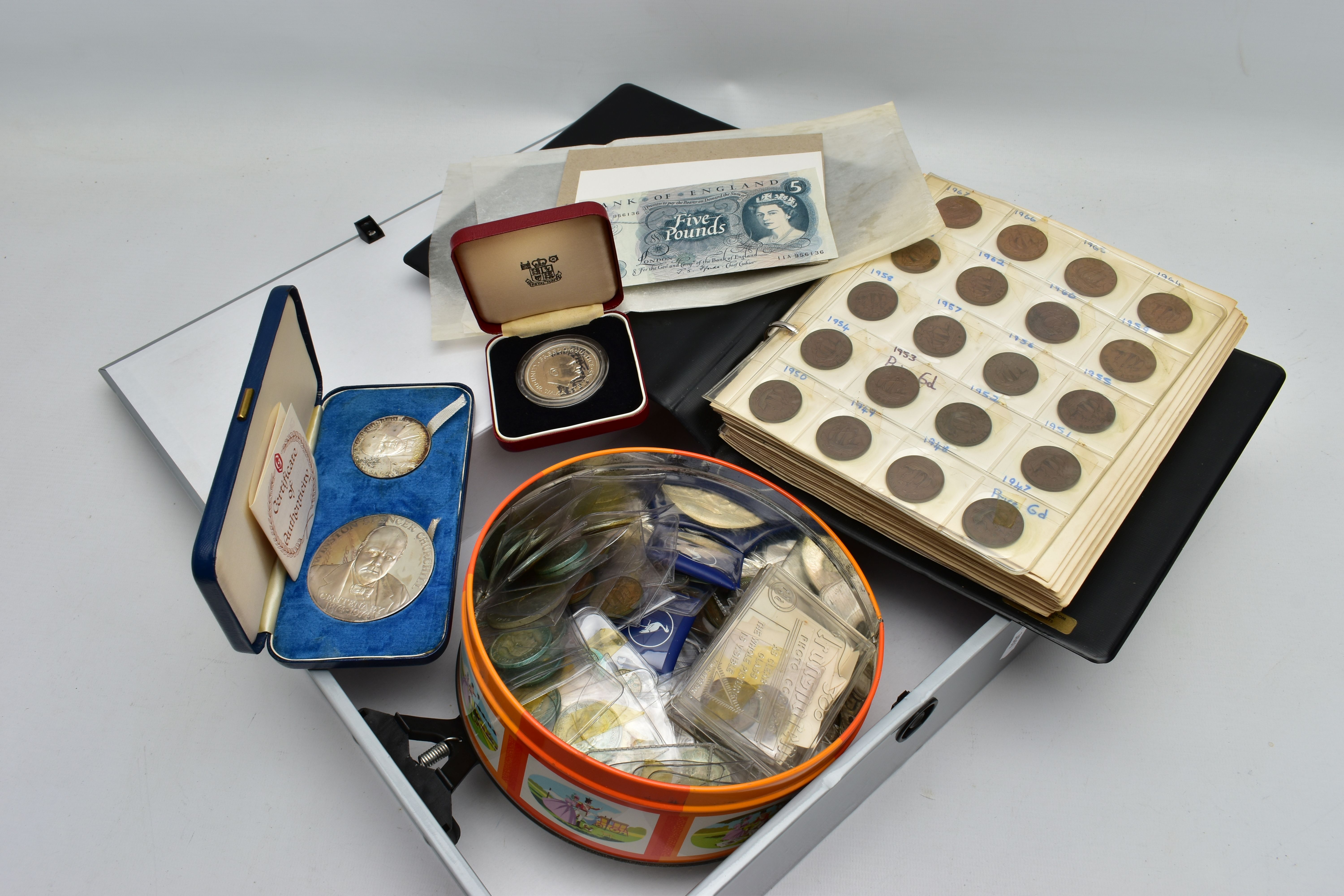 A TIN AND FILE CASE OF COINS AND BANKNOTES, to include a cased set of Sir Winston Churchill