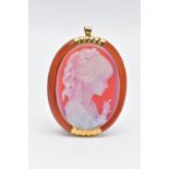 A YELLOW METAL CAMEO BROOCH, of an oval form, carved sardonyx cameo depicting a lady in profile with