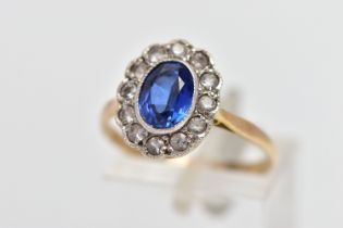 A 9CT GOLD SAPPHIRE AND CUBIC ZIRCONIA CLUSTER RING, the oval cut sapphire collet set, with circular