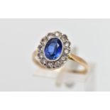 A 9CT GOLD SAPPHIRE AND CUBIC ZIRCONIA CLUSTER RING, the oval cut sapphire collet set, with circular