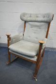 A MID CENTURY PARKER KNOLL MODEL PK 1031/4 TEAK ROCKING CHAIR (condition:-torn upholstered seat, and