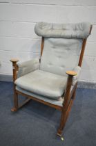 A MID CENTURY PARKER KNOLL MODEL PK 1031/4 TEAK ROCKING CHAIR (condition:-torn upholstered seat, and