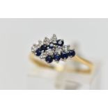 AN 18CT YELLOW AND WHITE GOLD SAPPHIRE AND DIAMOND DRESS RING, the marquise shape tiered cluster set