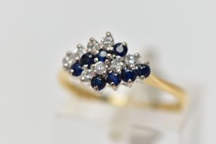 AN 18CT YELLOW AND WHITE GOLD SAPPHIRE AND DIAMOND DRESS RING, the marquise shape tiered cluster set
