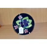 A MOORCROFT POTTERY PIN DISH DECORATED IN A VIOLET PATTERN, a second, bears silver line, painted and