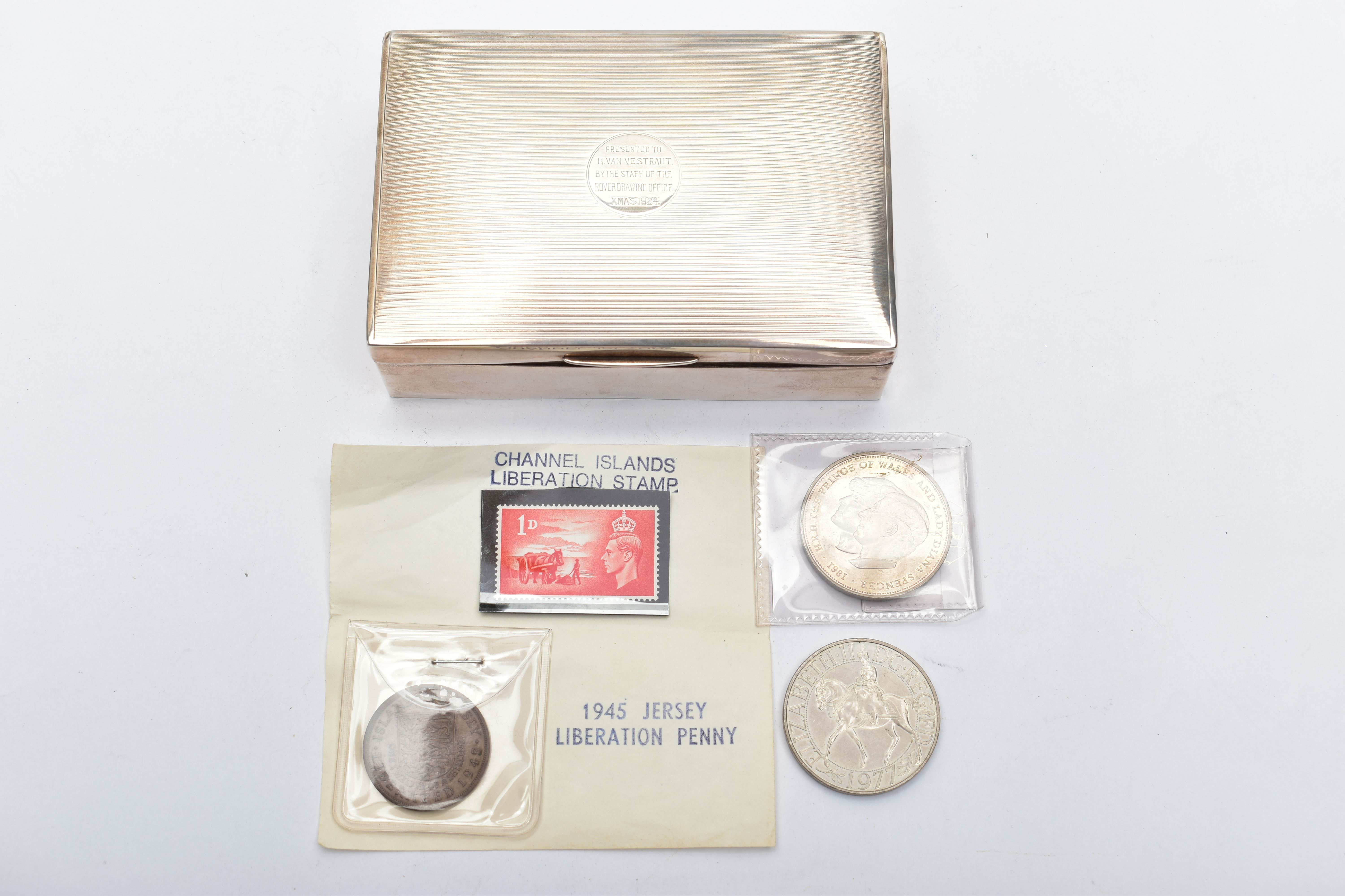 A SILVER CIGARETTE BOX AND COMMEMORATIVE COINS, rectangular cigarette case with an engine turned