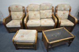 A FIVE PIECE WICKER CONSERVATORY SUITE, comprising a two seater sofa, a pair of armchairs, a pouffe,