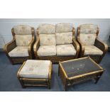 A FIVE PIECE WICKER CONSERVATORY SUITE, comprising a two seater sofa, a pair of armchairs, a pouffe,
