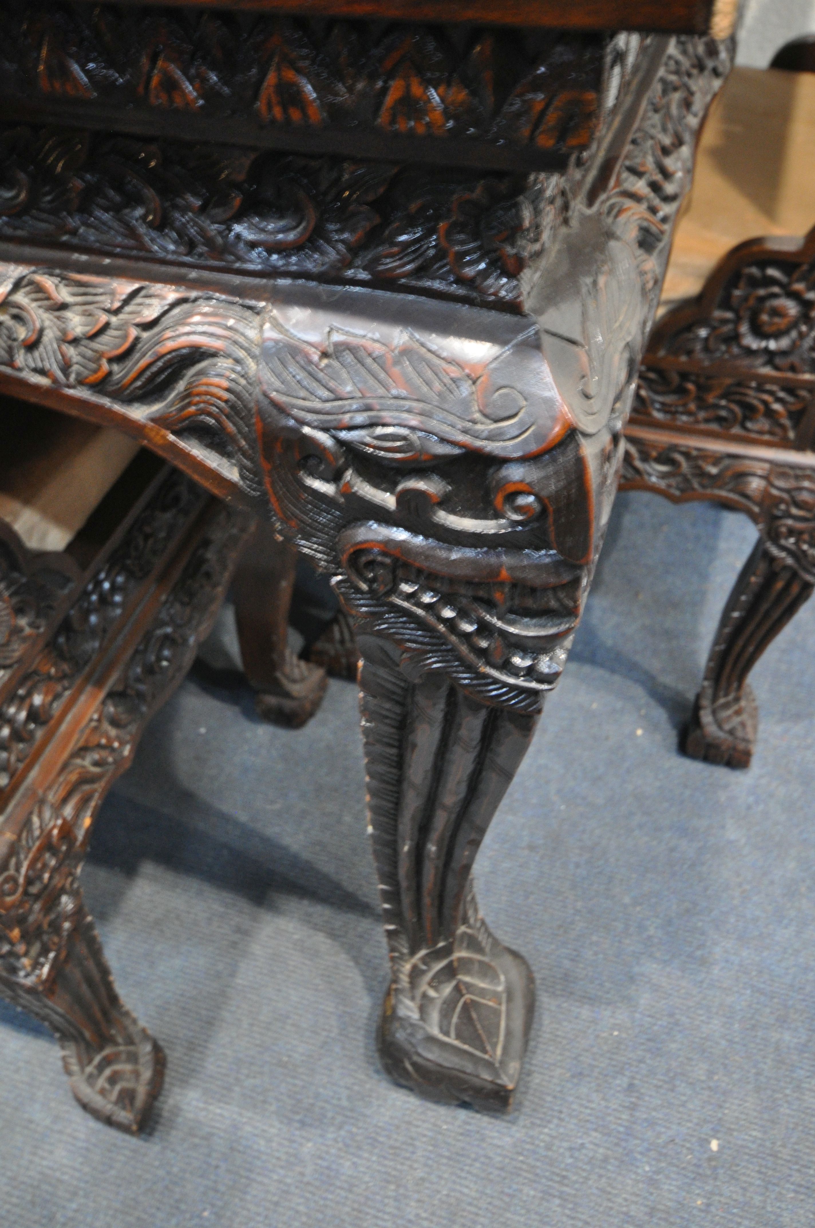 A 20TH CENTURY THAI ORIENTAL HEAVILY CARVED STAINED TEAK DINING TABLE, the recessed top with a - Image 3 of 7