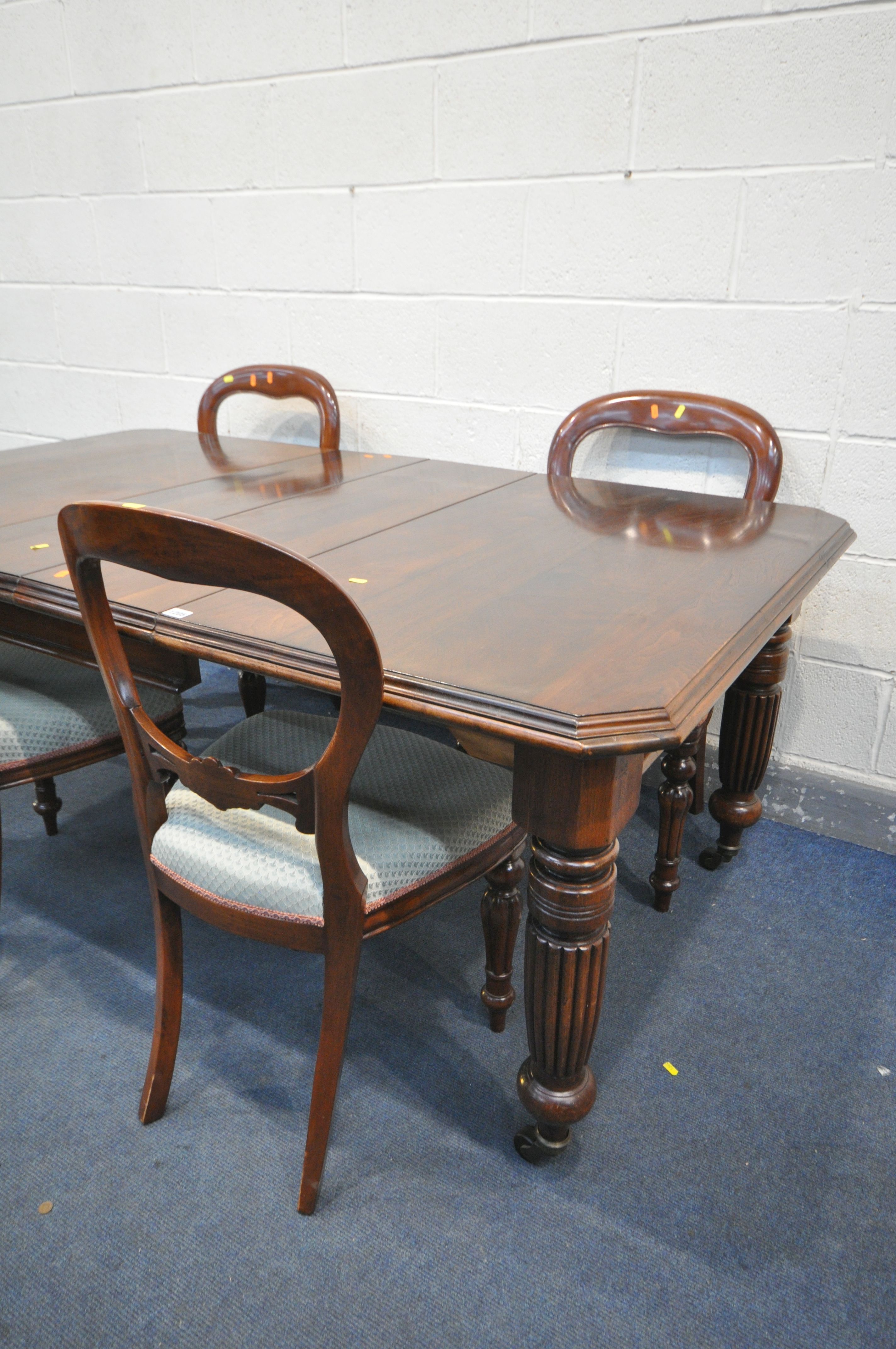 A VICTORIAN MAHOGANY WIND OUT DINING TABLE, with canted corners, two additional leaves, on fluted - Image 2 of 3