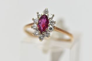 A 9CT YELLOW AND WHITE GOLD RUBY AND DIAMOND CLUSTER RING, set with a marquise shape ruby, within