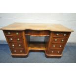 A VICTORIAN MAHOGANY KNEE HOLE DESK, serpentine centre, over a single frieze drawer, flanked by