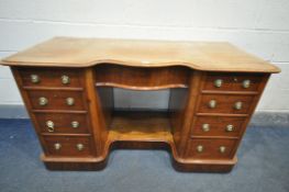 A VICTORIAN MAHOGANY KNEE HOLE DESK, serpentine centre, over a single frieze drawer, flanked by