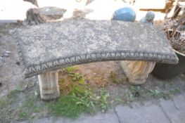 A COMPOSITE CURVED GARDEN BENCH, on twin scrolled supports, length 116cm x height 44cm