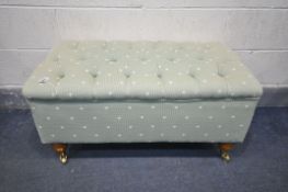 A GREEN UPHOLSTERED BUTTONED POUFFE, width 93cm x depth 53cm x height 46cm (condition:-good