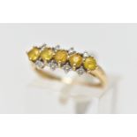 A 9CT GOLD GEM SET RING, designed with a central row of five circular cut yellow stones assessed