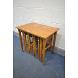 IN THE MANNER OF POUL HUNDEVAD, A MID CENTURY TEAK NEST OF TABLES, comprising a later rectangular